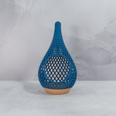 "Sitting, front-facing, empty WOOD AND LIGHT BLUE TEARDROP planter, showcasing its charming wood base and soft light blue pattern."